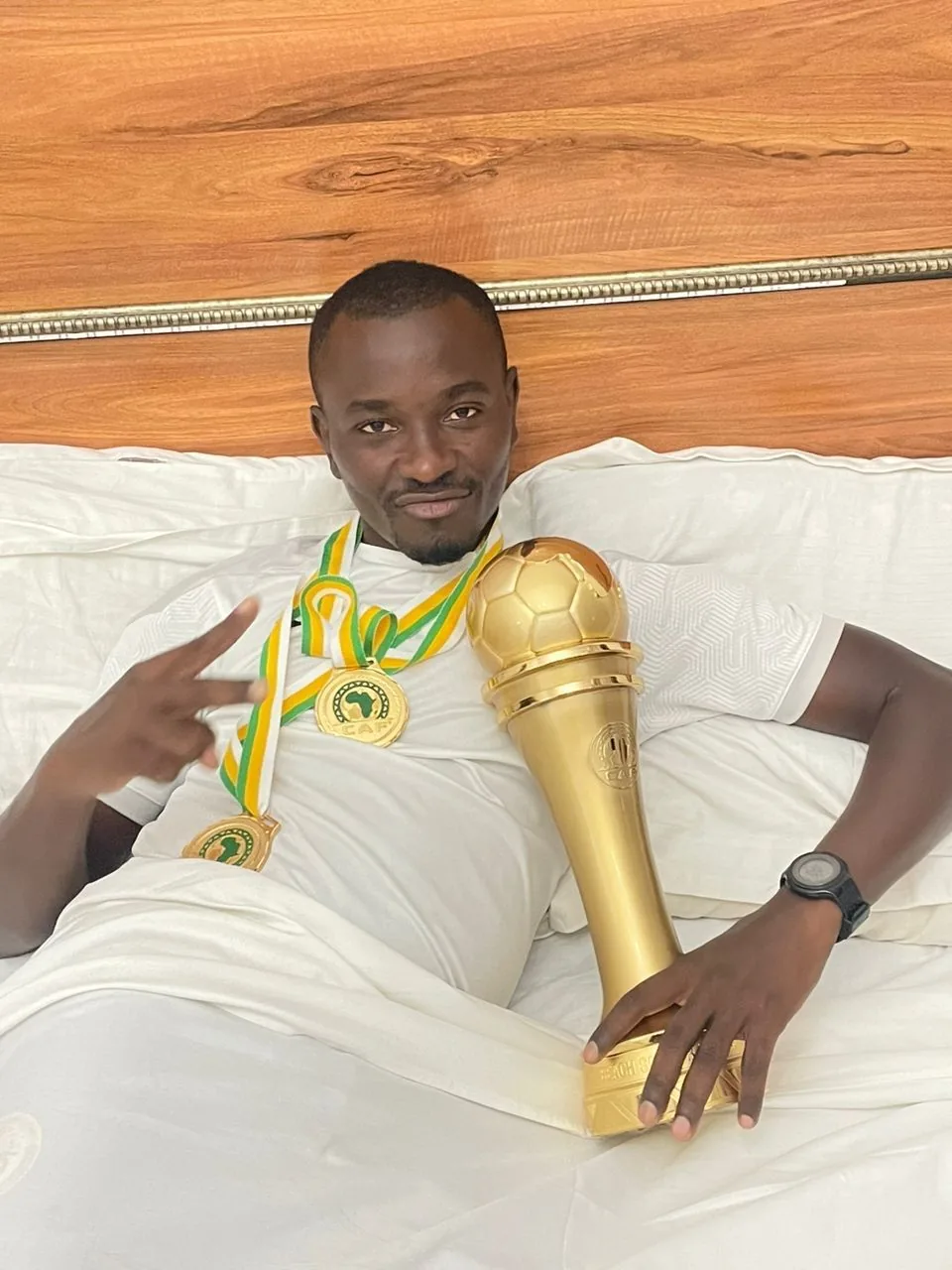 Sportif sénégalais médaillé tenant un trophée